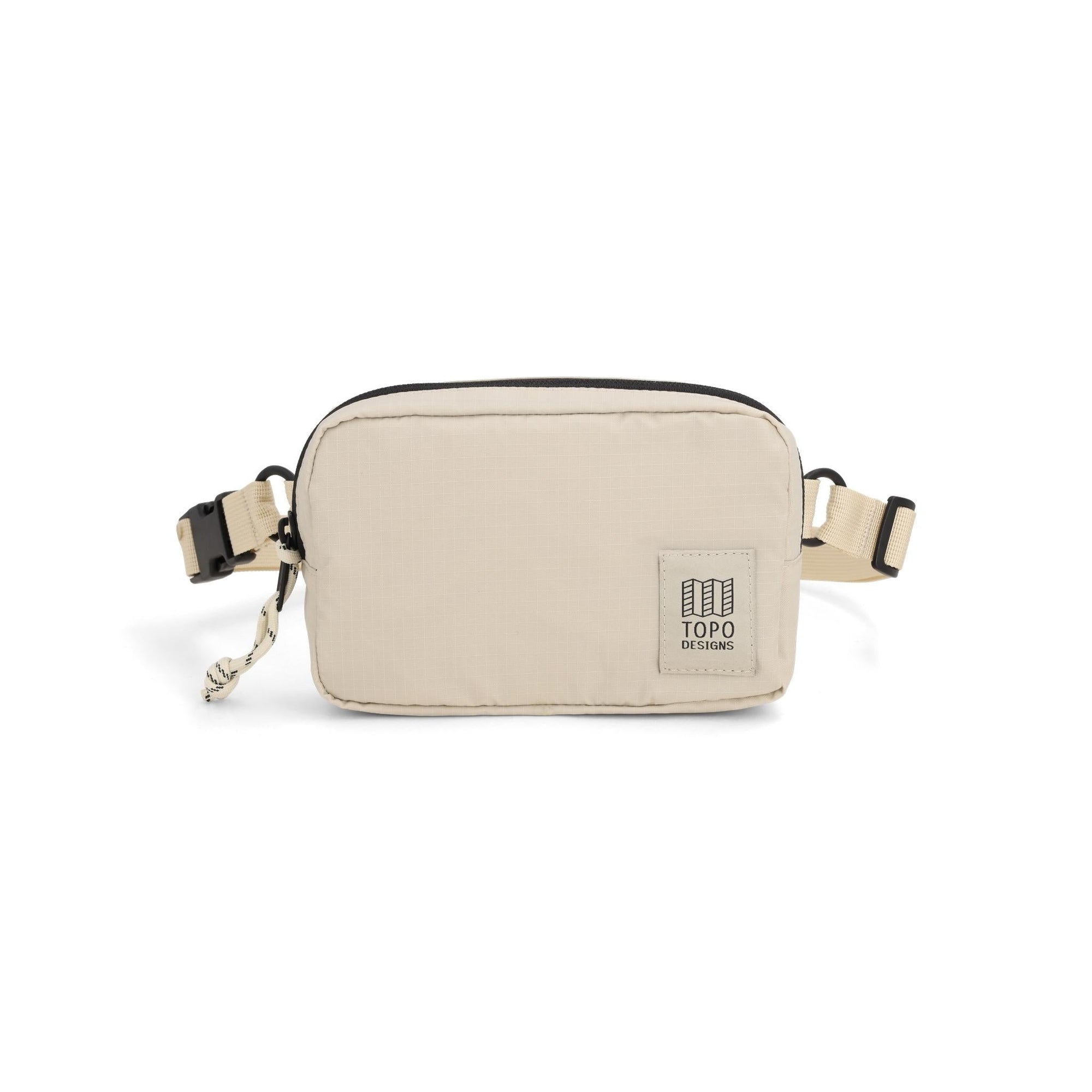 Cream colored ripstop belt bag with adjustable webbing strap and front logo patch