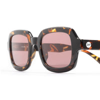 Oversized square sunglasses with tortoiseshell frames and rose-tinted lenses, three-quarter view