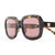 Oversized square sunglasses with tortoiseshell frames and rose-tinted lenses, three-quarter view
