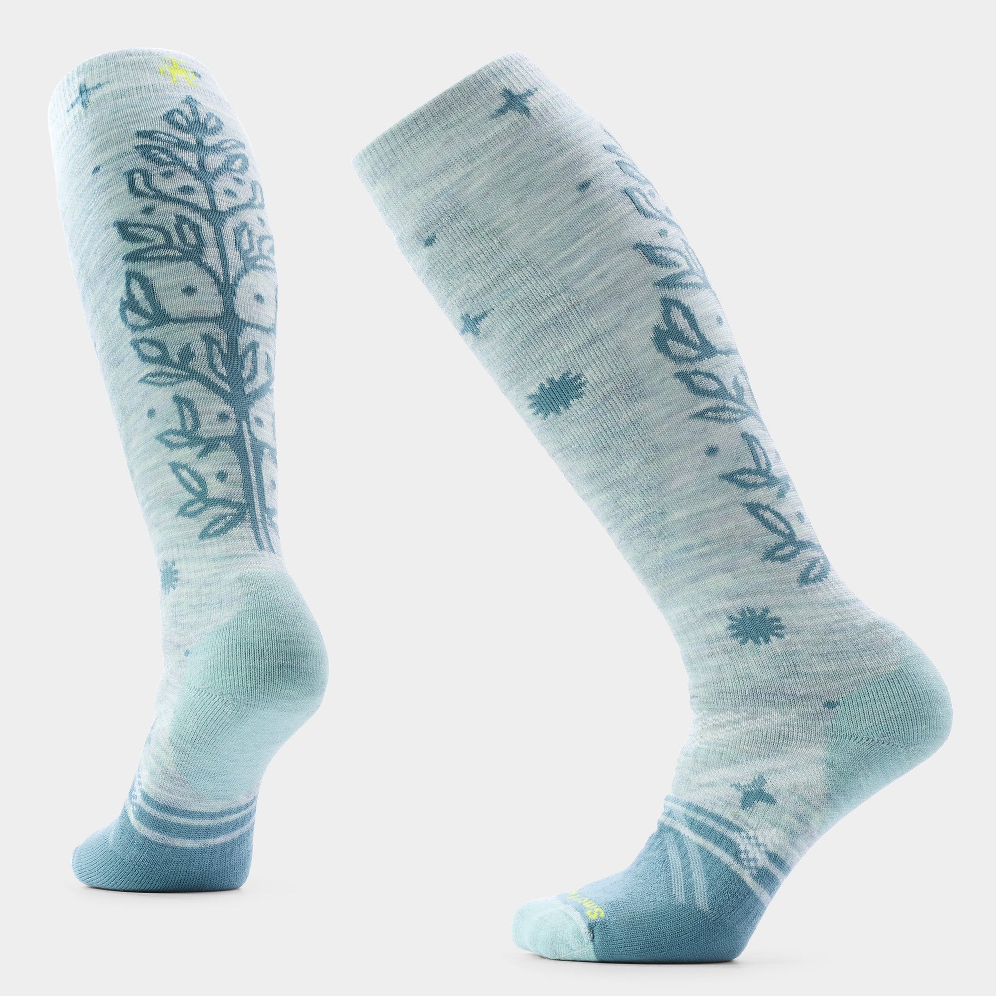 Knee-high ski socks in mint green with floral vine and star patterns, shown front and back views
