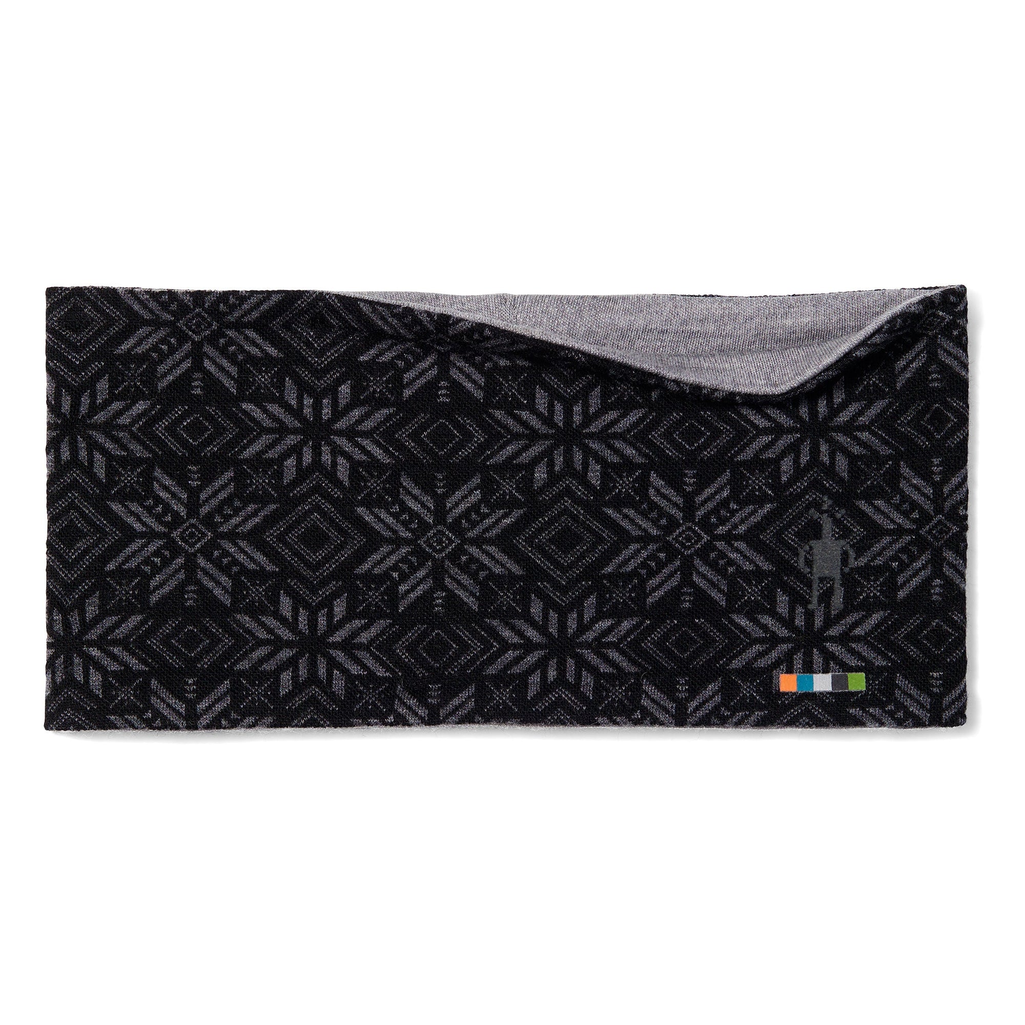 Reversible merino wool headband with black geometric fair isle pattern and gray interior, flat lay view