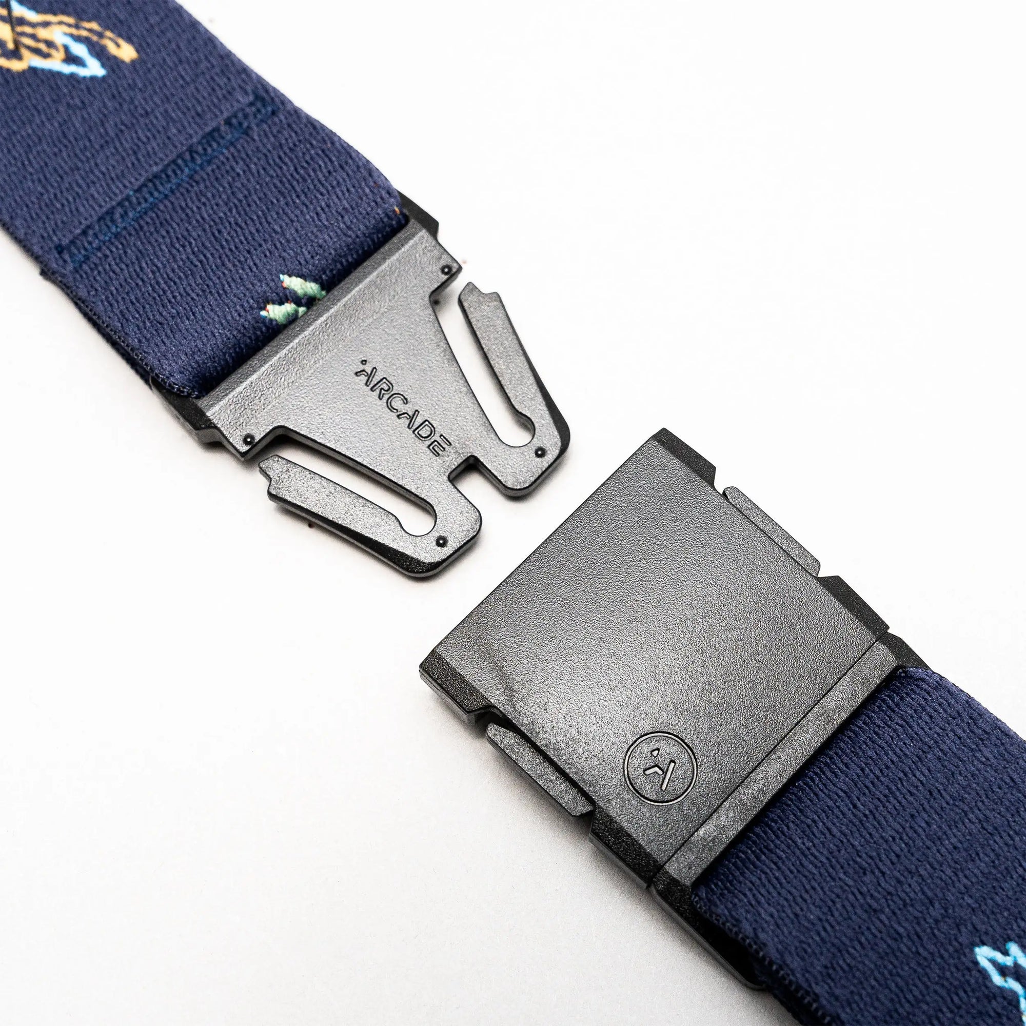 Navy blue webbing belt with adjustable buckle system shown unbuckled on white background