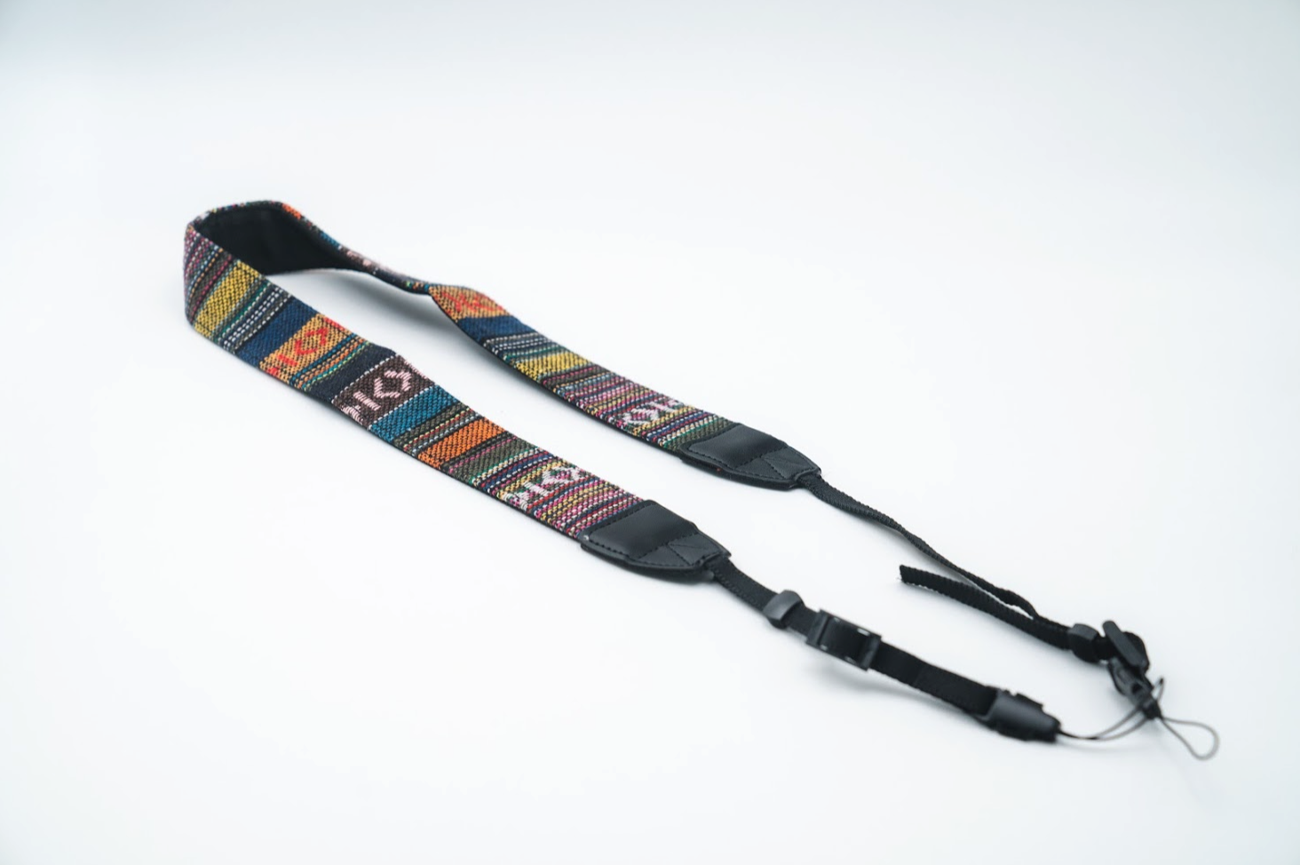 Multicolor woven tapestry camera strap with black adjustable ends and quick-release clips