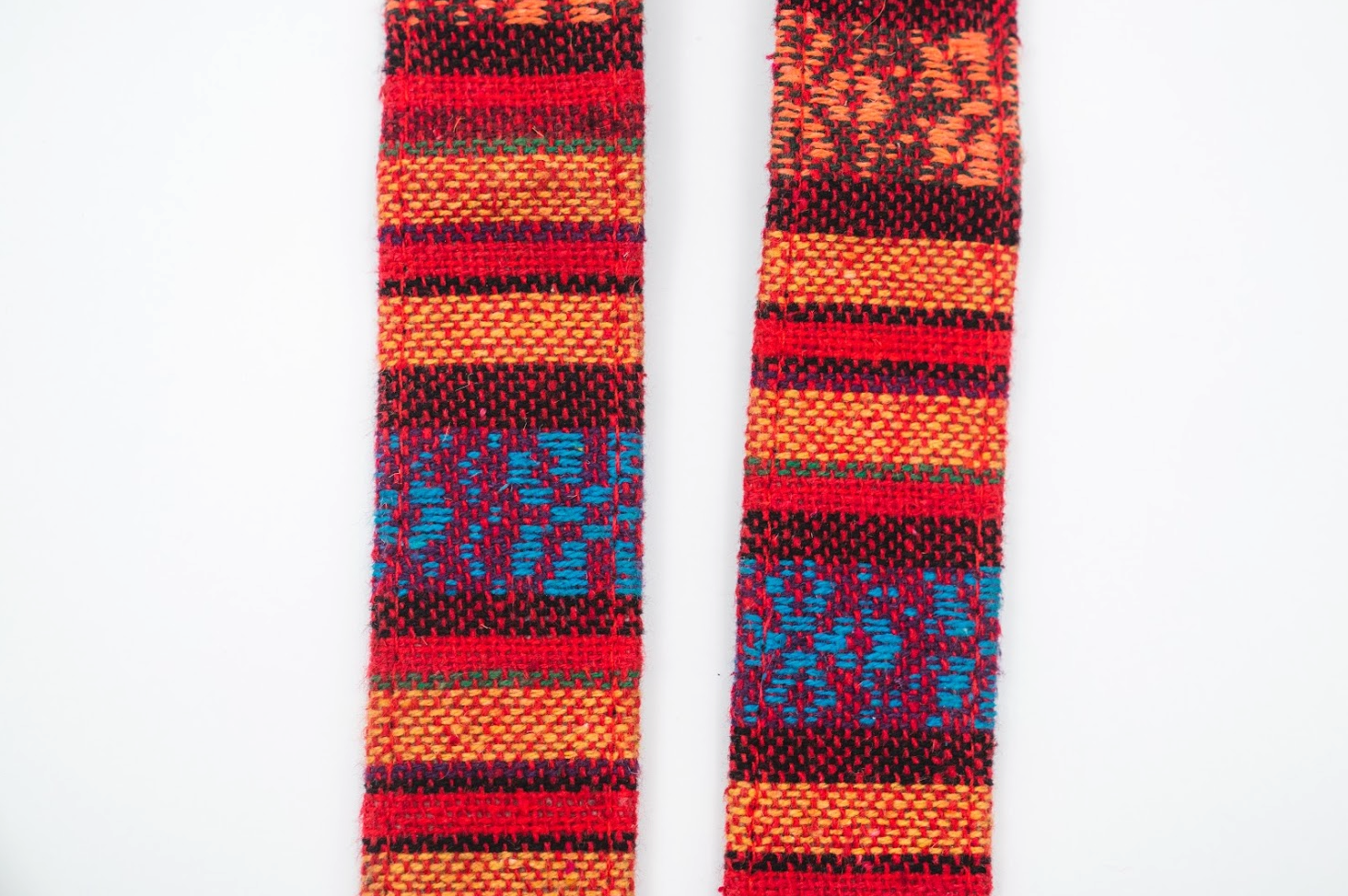 Woven tapestry camera strap with multicolor geometric pattern, shown front and back sides