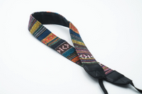 Multicolor woven tapestry camera strap with ethnic geometric pattern and black leather hardware ends