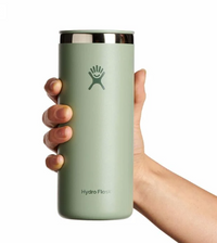 Sage green insulated tumbler with stainless steel lid being held in hand