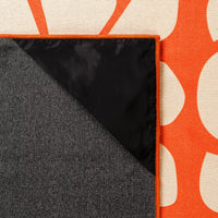 Reversible blanket towel with orange floral pattern on one side and gray on reverse
