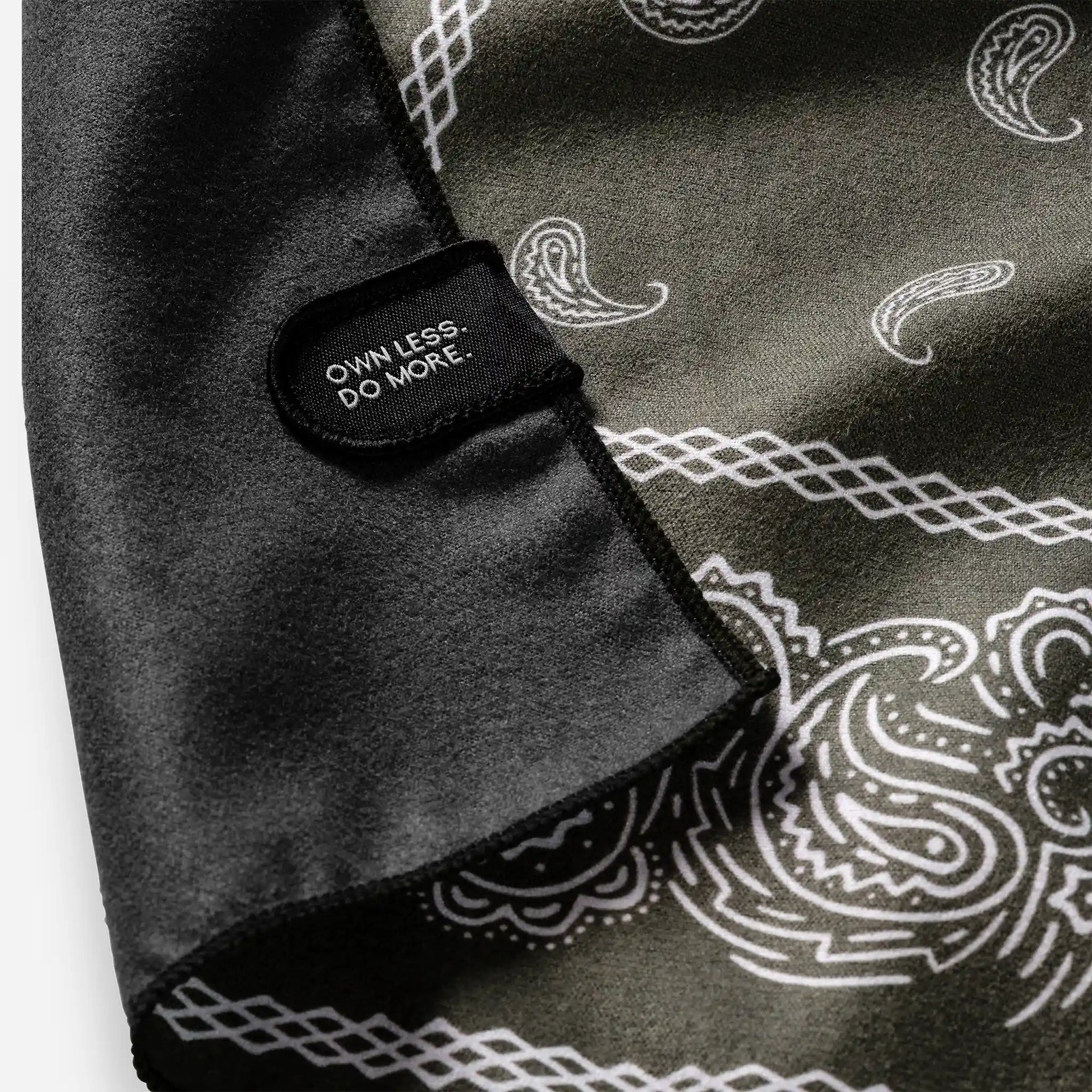 Folded bandana towel with paisley pattern and black label tab