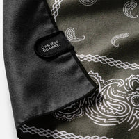 Folded bandana towel with paisley pattern and black label tab