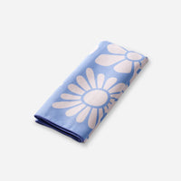 Folded lightweight towel with blue background and white daisy flower pattern
