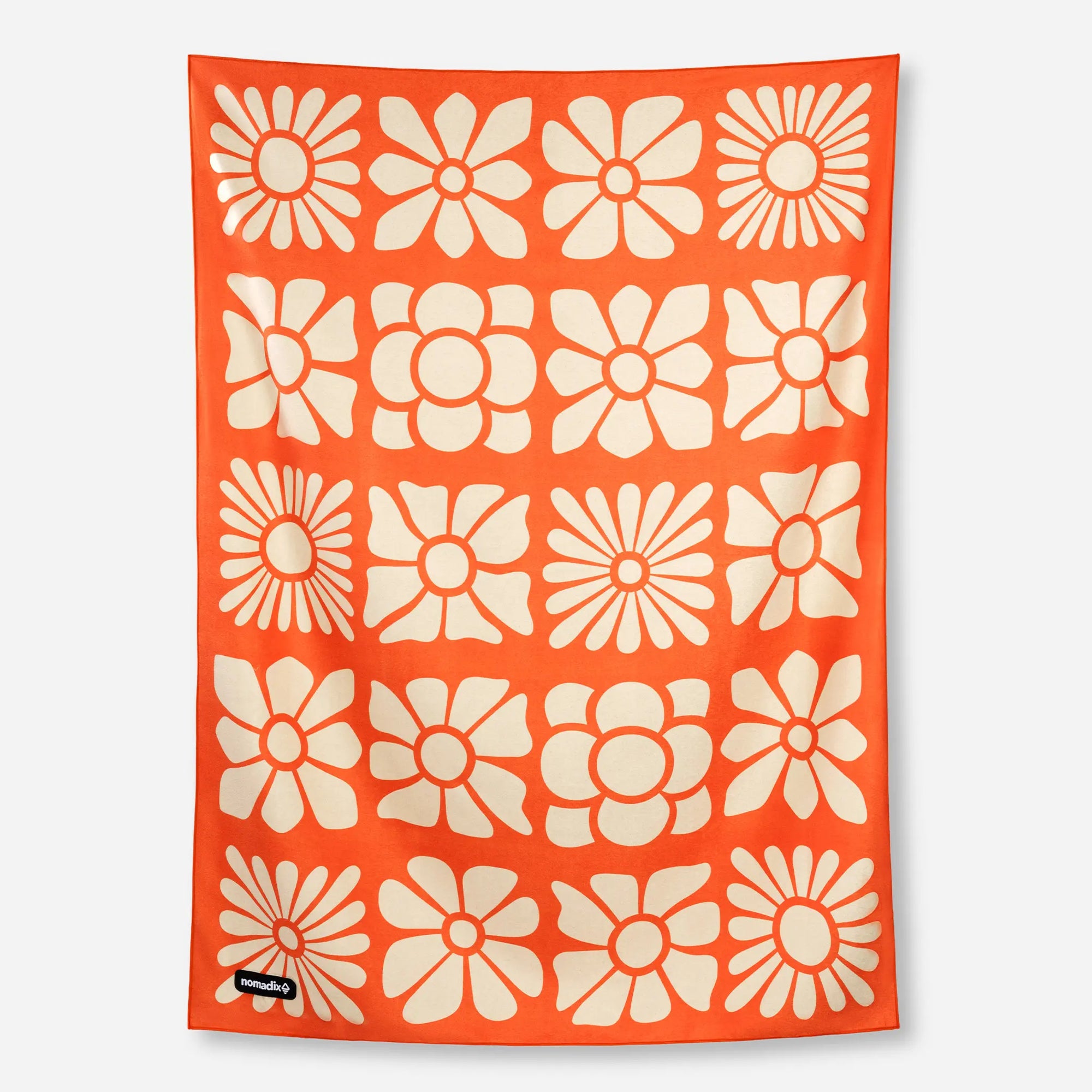 Orange blanket towel with cream floral pattern featuring daisies and flowers in grid layout