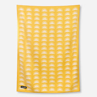 Yellow blanket towel with white sun pattern displayed flat against neutral background