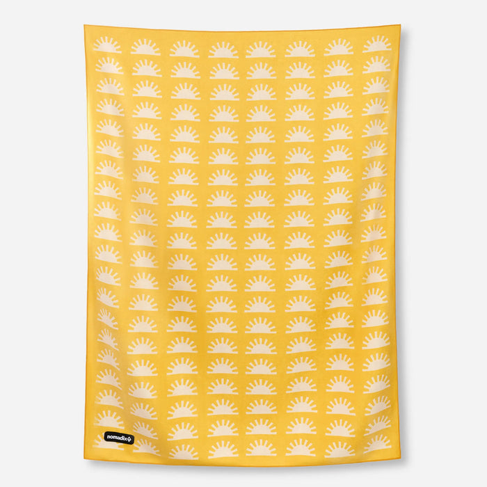 Yellow blanket towel with white sun pattern displayed flat against neutral background