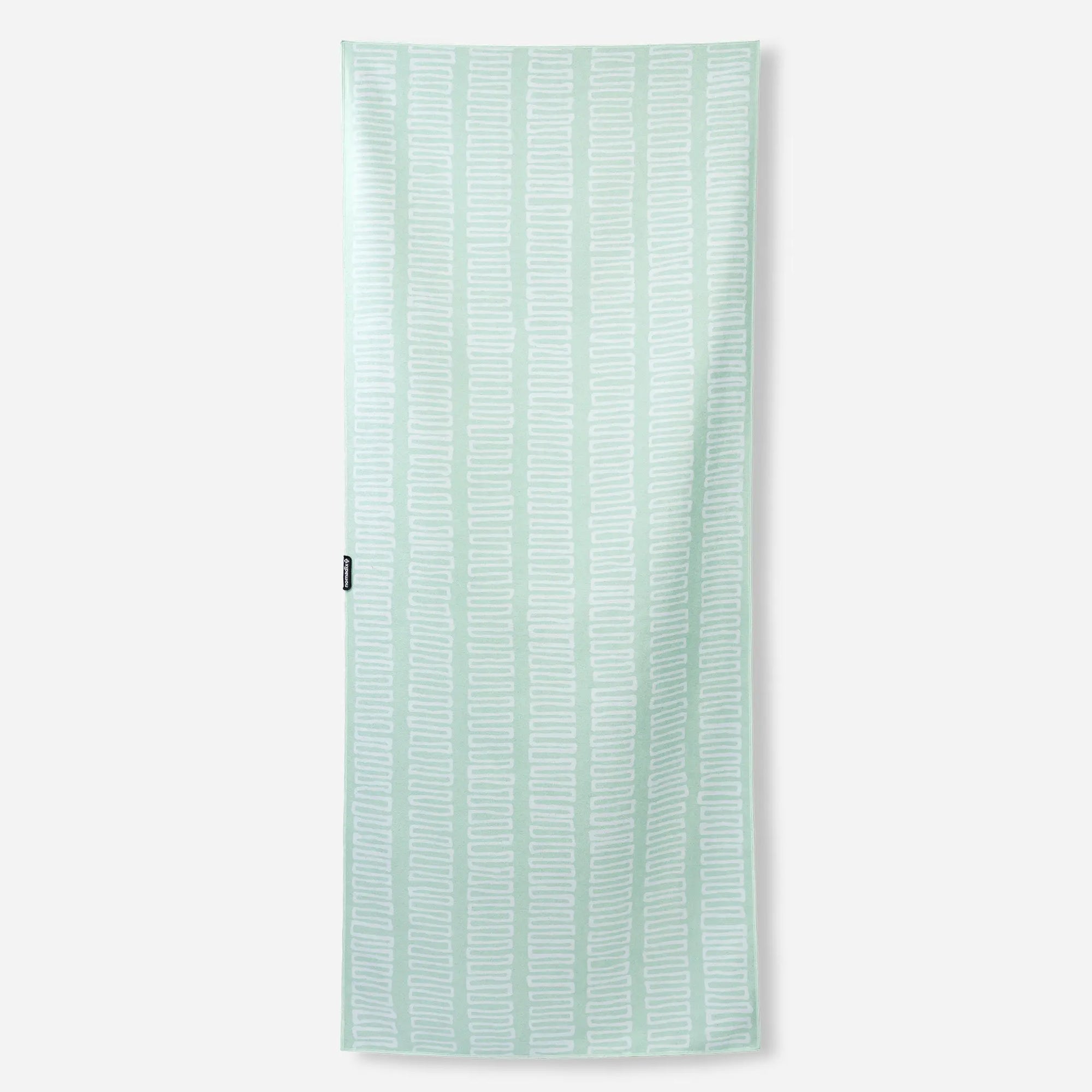 Light green towel with white geometric zigzag pattern displayed flat against white background