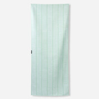 Light green towel with white geometric zigzag pattern displayed flat against white background