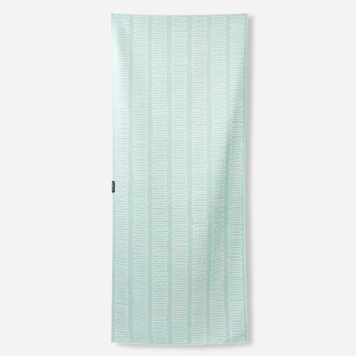 Light green towel with white geometric zigzag pattern displayed flat against white background