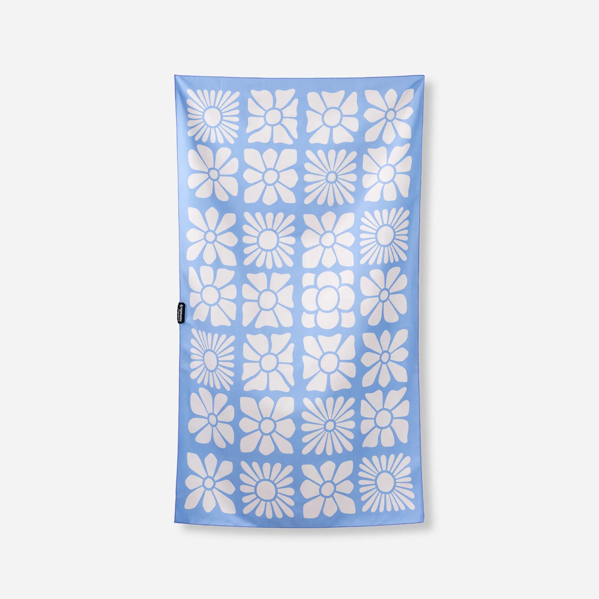 Light blue microfiber towel with repeating white flower pattern arranged in grid