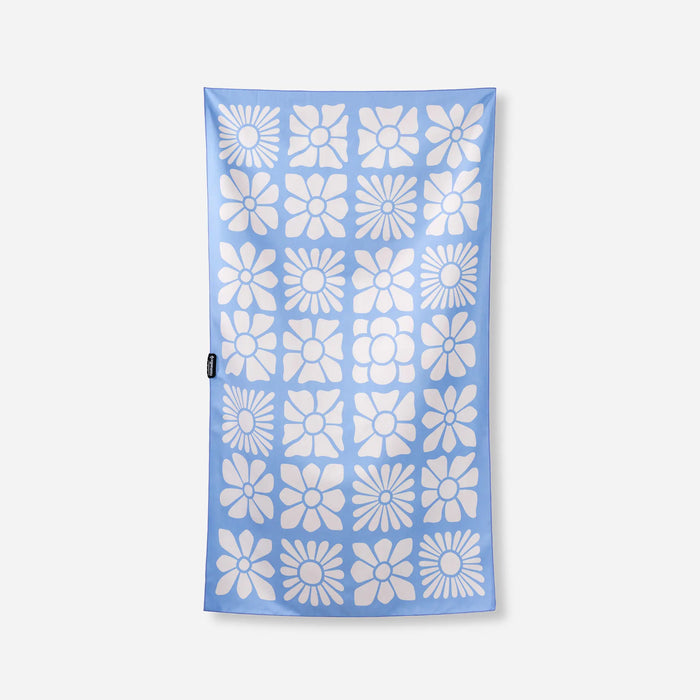 Light blue microfiber towel with repeating white flower pattern arranged in grid