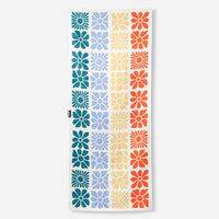 Rectangular towel with colorful geometric flower pattern in grid layout on white background
