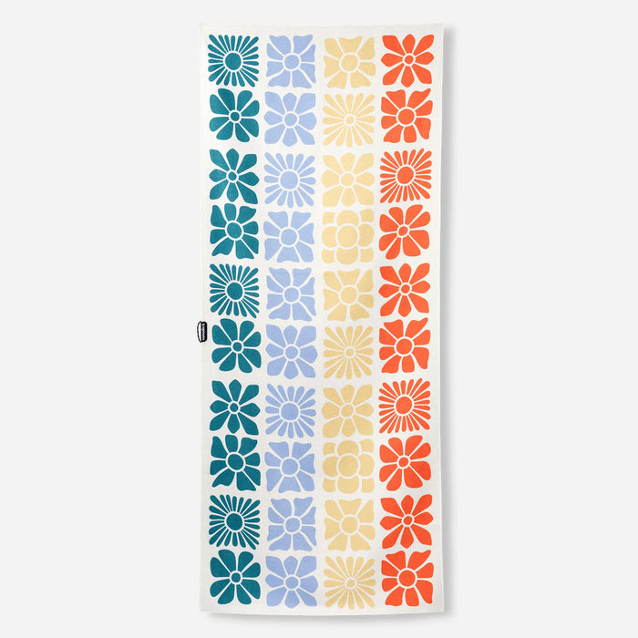 Rectangular towel with colorful geometric flower pattern in grid layout on white background