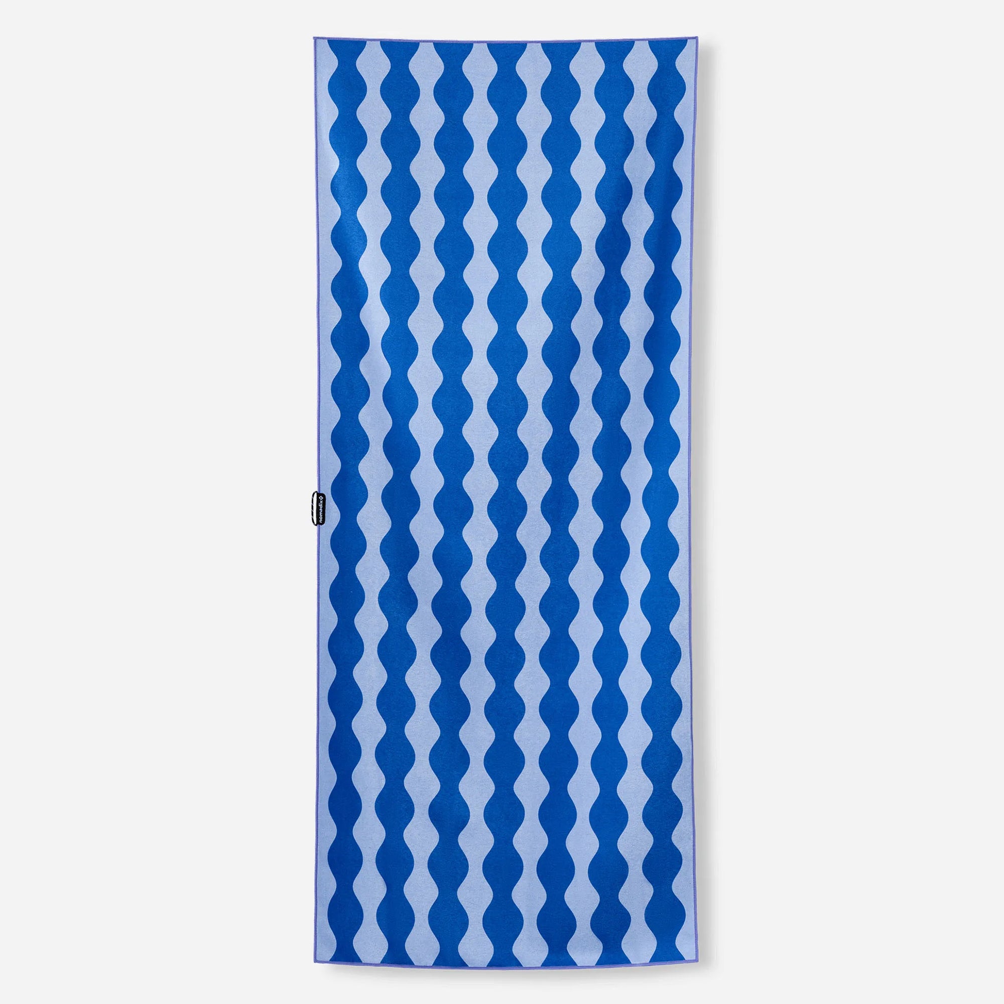 Rectangular towel with blue and white wavy geometric pattern displayed flat against white background