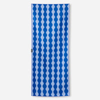 Rectangular towel with blue and white wavy geometric pattern displayed flat against white background