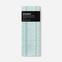 Seafoam green towel with white geometric pattern in retail packaging