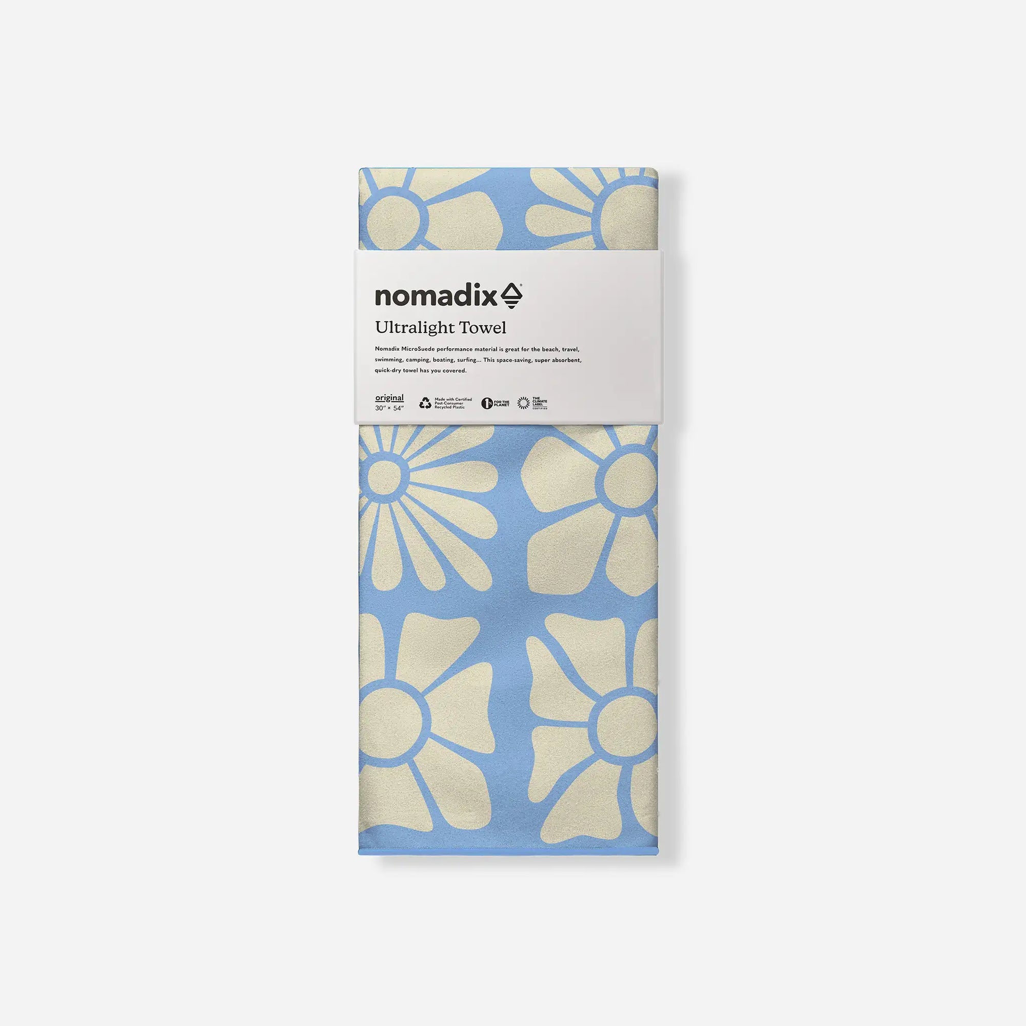 Packaged ultralight towel with floral pattern in blue and cream colors, studio shot