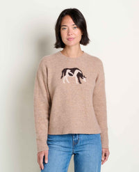 Women's crew neck knit sweater in tan with cow animal jacquard pattern, front view on model
