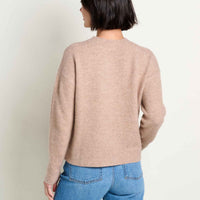 Women's crew neck knit sweater in tan, back view, paired with blue jeans