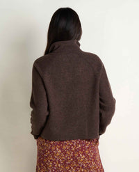 Women's quarter-zip fleece pullover in dark brown, back view, paired with floral skirt