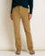 Women's slim-fit corduroy pants in warm tan, front view, paired with sandals