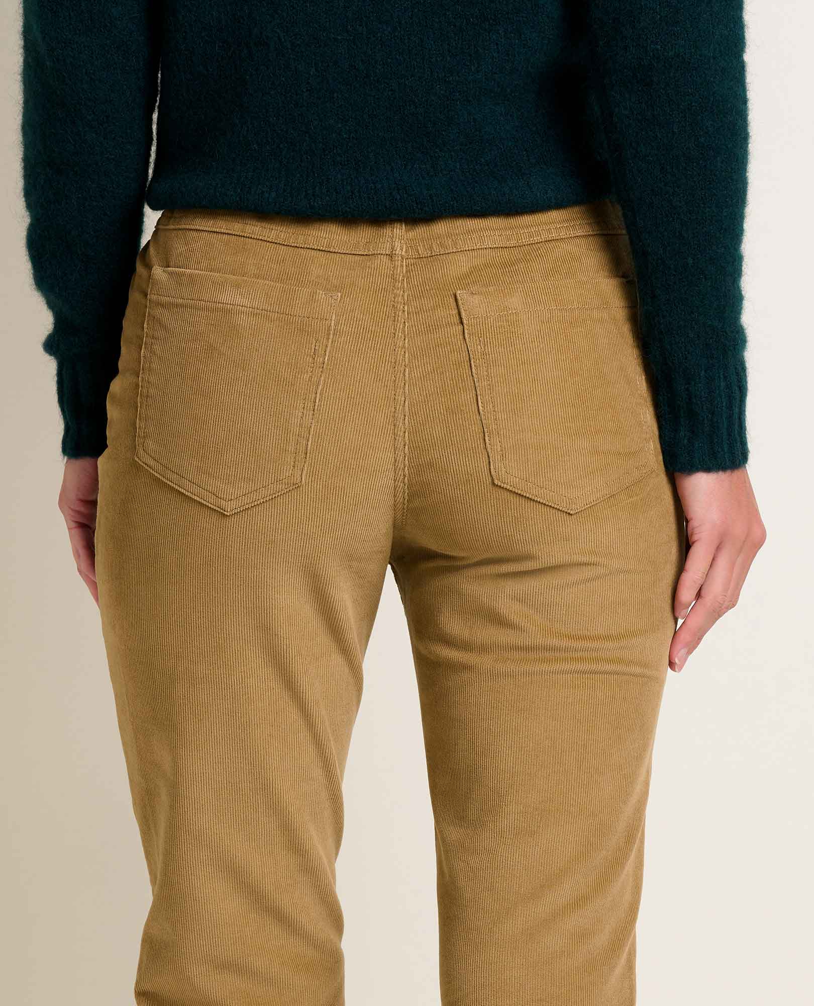 Women's slim corduroy pants in tan, back view showing two back pockets