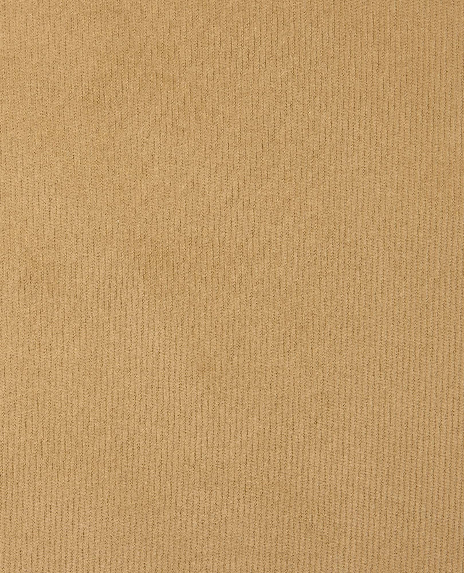 Close-up of ribbed corduroy fabric texture in warm tan, showing fine wale cord detail