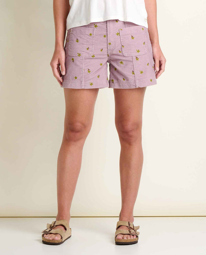 Light purple corduroy shorts with yellow floral embroidery pattern, front view on model