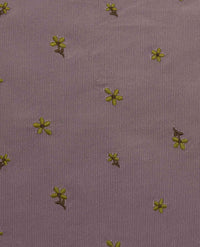 Purple corduroy fabric with small yellow embroidered flowers scattered across surface