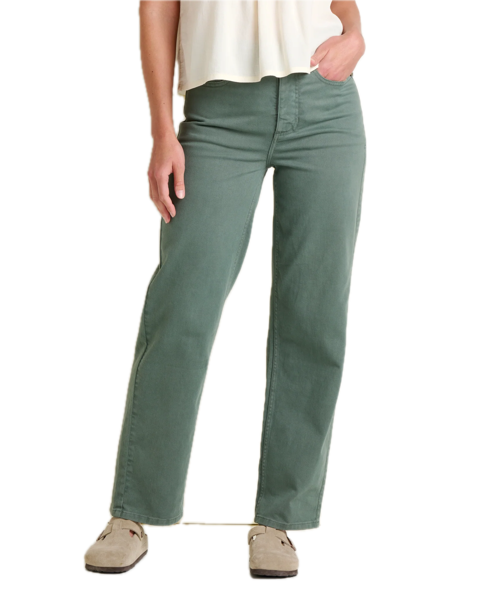 Sage green straight leg pants worn with cream top and tan shoes, front view