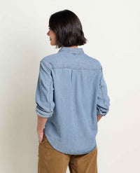 Women's denim long-sleeve shirt, back view, with rolled cuffs and curved hem