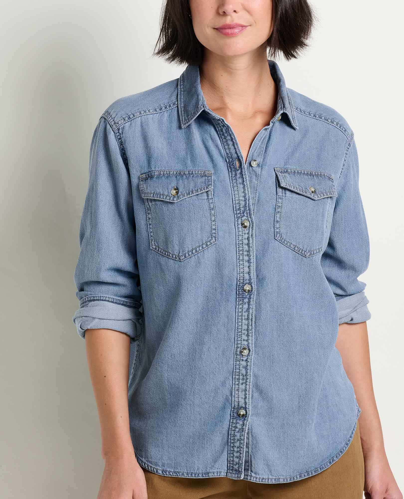 Women's light wash denim button-up shirt with dual chest pockets and rolled sleeves, front view