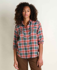Women's long-sleeve flannel plaid button-up shirt with chest pockets, front view on model