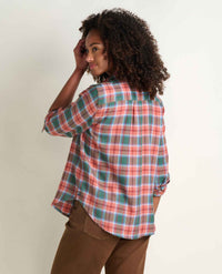 Women's plaid flannel shirt in coral and teal check, back view on model with rolled sleeves
