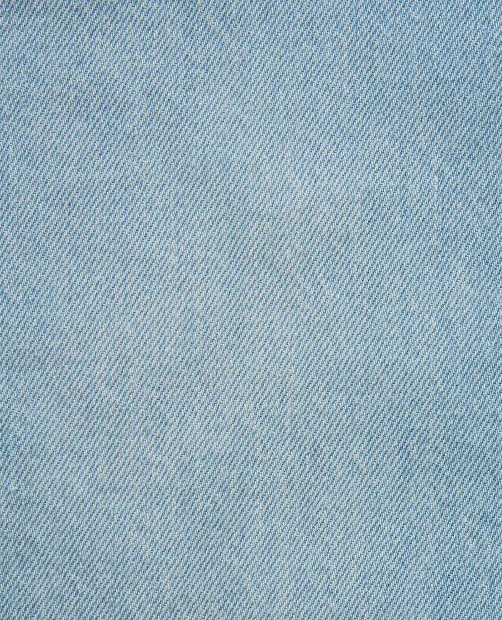 Close-up fabric swatch of light wash blue denim with classic diagonal twill weave