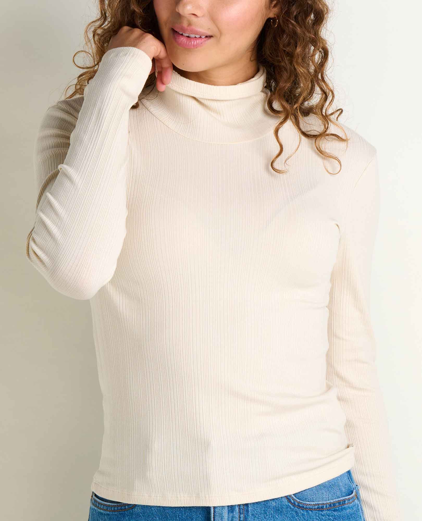 Women's ribbed turtleneck long-sleeve top in cream, close-up front view on model