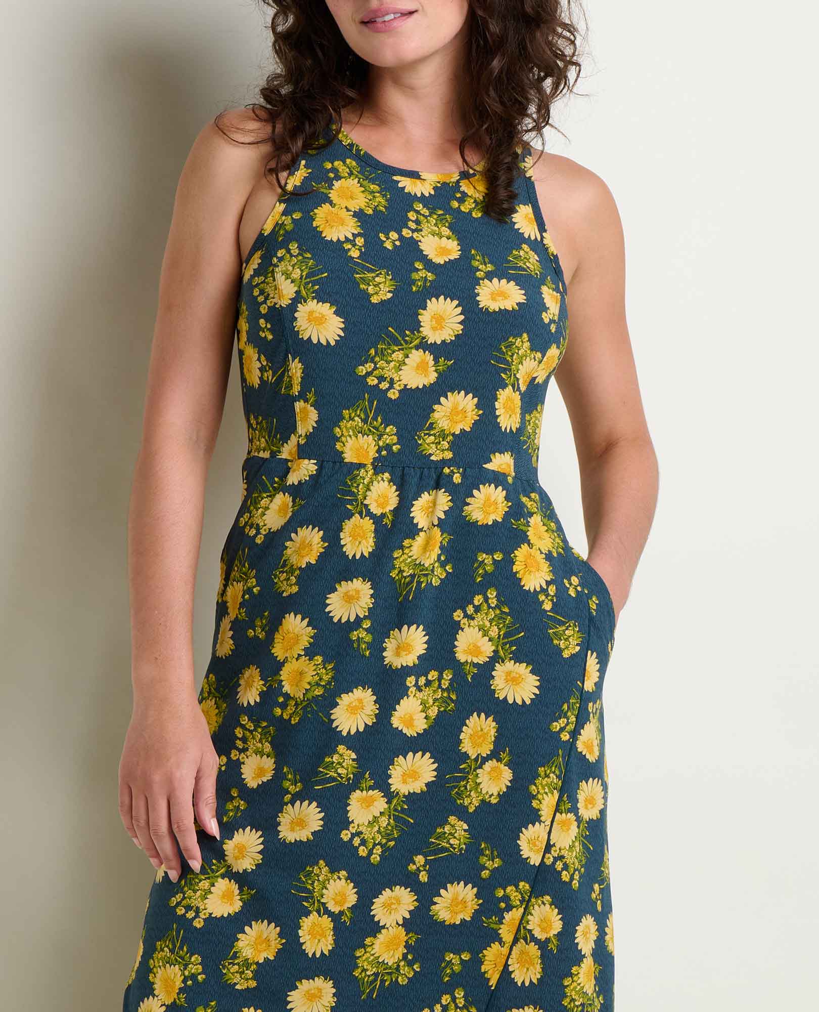 Sleeveless maxi dress with yellow daisy print on navy background, fitted waist