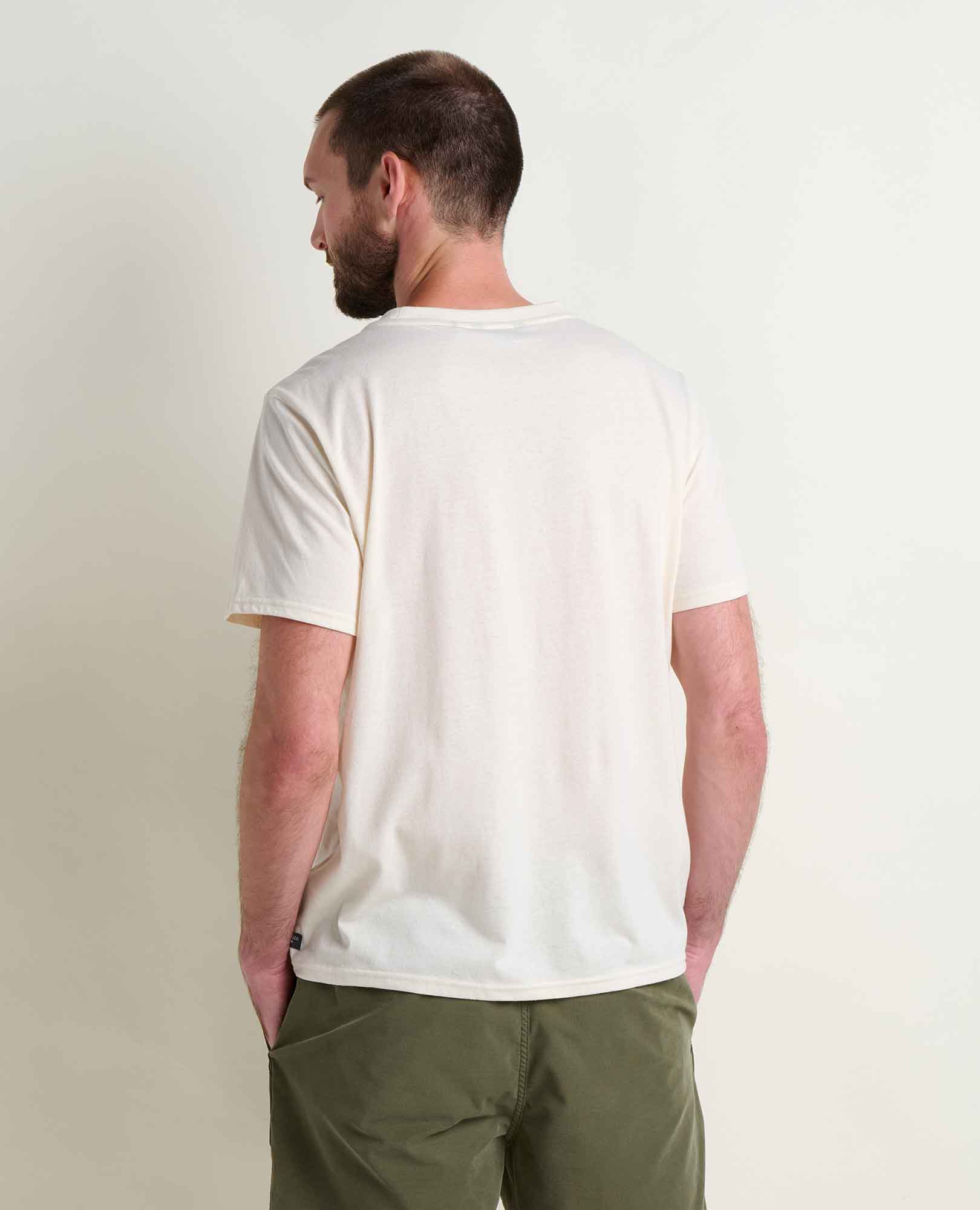 Cream colored crew neck t-shirt with embroidered design, back view on male model