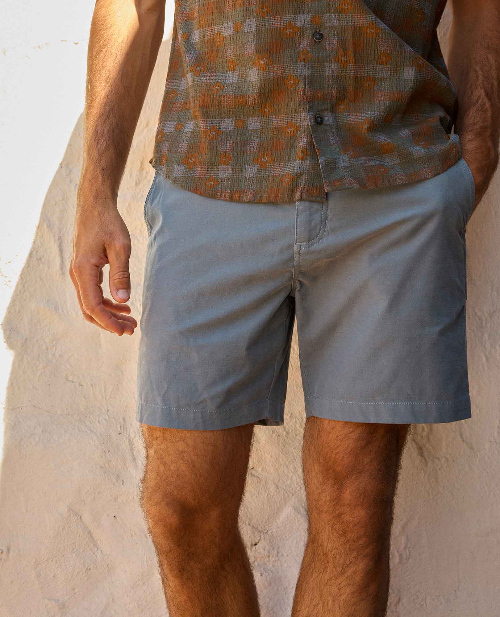 Light blue chino shorts worn by man, front view showing casual fit and styling