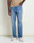 Men's straight fit blue jeans in medium wash denim, front three-quarter view on model