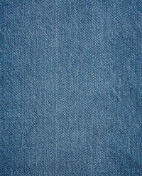 Close-up fabric detail of medium wash blue denim with diagonal twill weave texture