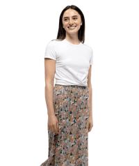 White short-sleeve crew neck t-shirt on model with floral patterned skirt