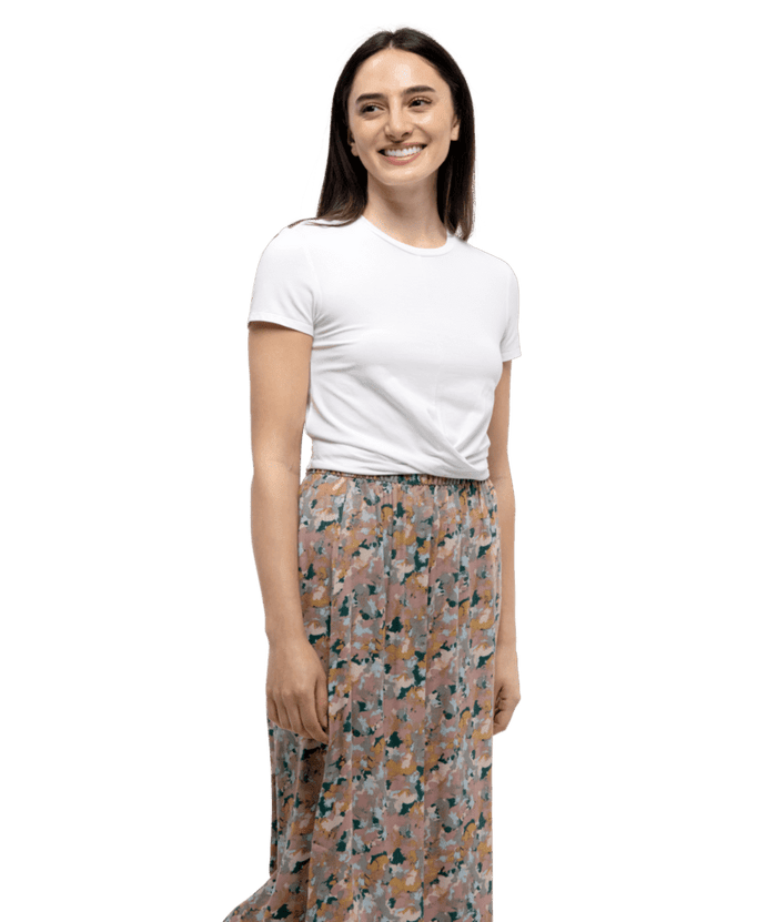 White short-sleeve crew neck t-shirt on model with floral patterned skirt